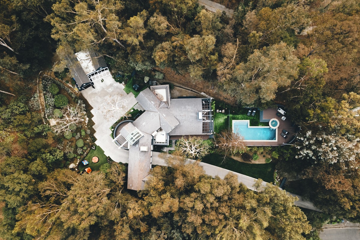 Aerial view of luxury estate with pool set among trees in Southern California