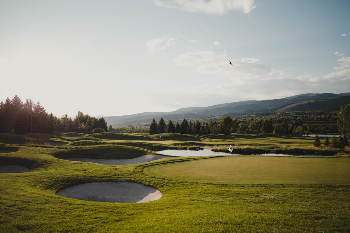 Luxury par 3 golf course with rolling hills and mountain views